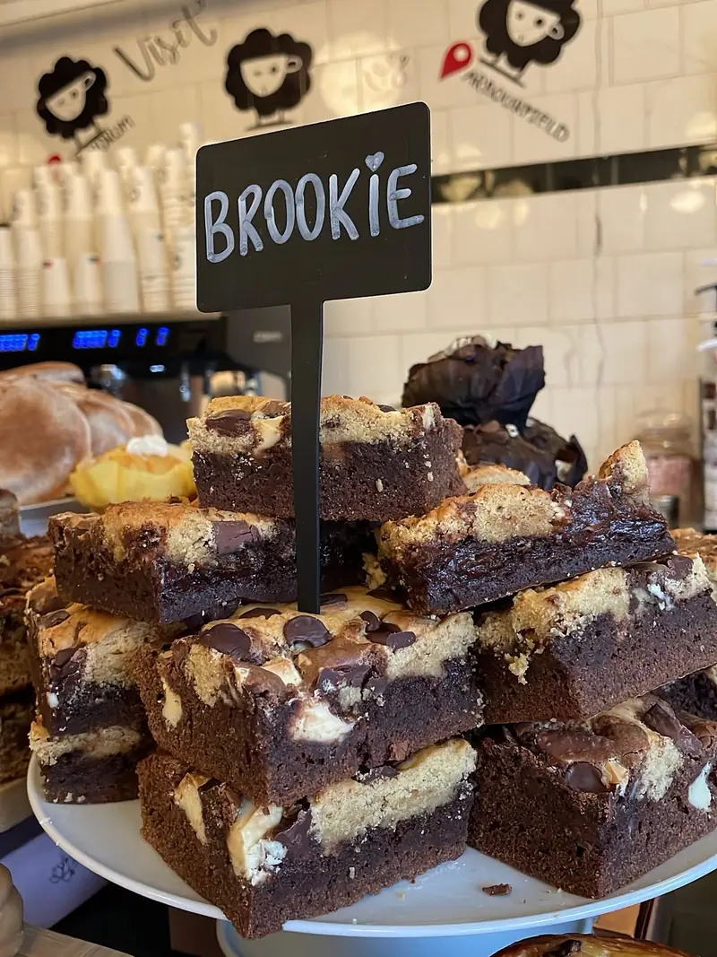 Brookies stacked on the counter under a handwritten Brookie sign